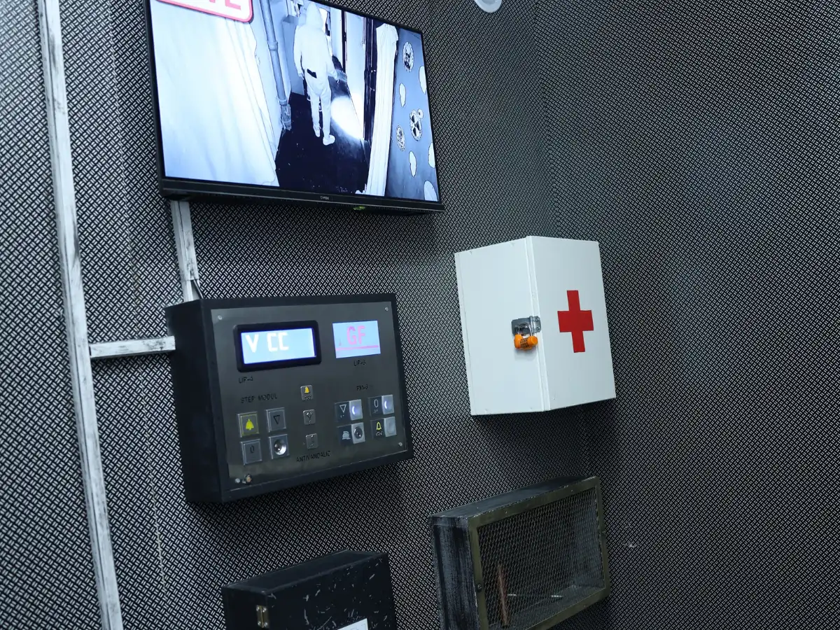 Kontrolna soba escape room avanture Panic Room sa nadzornim monitorom, upravljačkom tablom i ormarićem prve pomoći